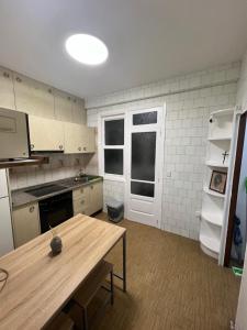 a kitchen with a wooden table in a room at alojamiento A&A in Vigo