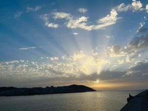 a cloudy sky over a body of water at Centro, playa y puesta de sol in A Coruña