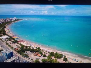 an aerial view of a beach with people and the ocean at Sweet home in Maceió