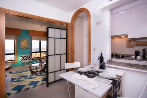 a kitchen with a table with plates on it at Centro, playa y puesta de sol in A Coruña