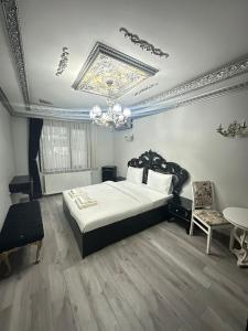 a bedroom with a large bed and a chandelier at X SAPANCA OTEL in Sakarya