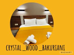 a hotel room with a bed with towels on it at Crystal Wood Apartment 213 in Bakuriani