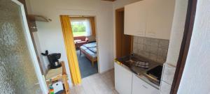 a kitchen and a living room with a couch at Ferienwohnung "Kleine Deichperle" in Prerow