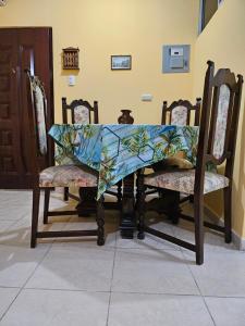 a table with chairs with a table cloth on it at Blanca Apartments in Guayaquil