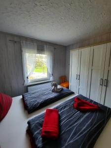 a bedroom with two beds and a teddy bear on the bed at Haus Seeblick in Roßbach