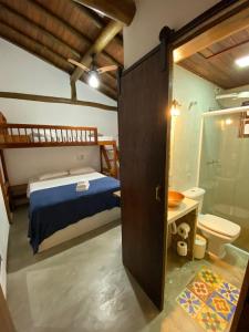 a bedroom with a bed and a bathroom with a toilet at Lalabella Itaguá in Ubatuba +202 photos