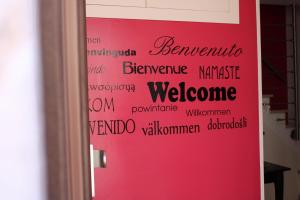 a wall with words on a pink door at Room and Breakfast Luciana Sant'Elia a Pianisi in SantʼElia a Pianisi