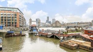 a river with boats docked in a city at London Bermondsey 4 People Studio in the Center in London