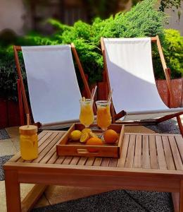 a tray of fruit and two drinks on a table at Hotel Kasieńka in Hrubieszów