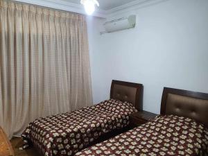 Llit o llits en una habitació de Noor Apartment