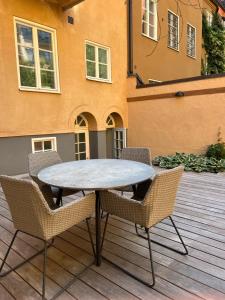 a table and chairs sitting on a patio at Executive Living Östermalm Suite and Studios in Stockholm