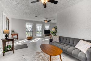 uma sala de estar com um sofá e uma mesa em Charming Austin Home on 2 Acres 11 Mi to Dtwn! em Bee Cave