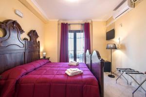 a bedroom with a large bed with a purple bedspread at The Life in Marcellina
