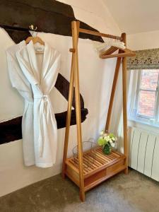 a dressing room with a white robe and a shelf at Sophisticated Hidden Gem for 2 in Lovely Ludlow in Ludlow