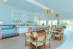 a restaurant with tables and chairs and a swimming pool at Rio Quente Resorts - Hotel Pousada in Rio Quente