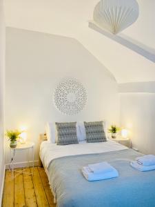 a bedroom with a bed with two towels on it at Beautiful sea view, tranquil loft apartment in Lytham St Annes