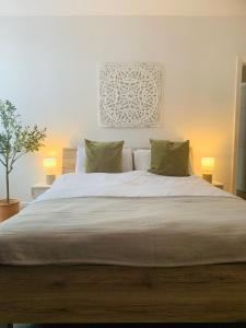 a bedroom with a large bed with two pillows at Beautiful sea view, tranquil loft apartment in Lytham St Annes