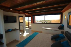 a room with a bed and a large window at Crystalsuite. Beautiful penthouse with sea views in Corralejo