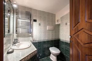 a bathroom with a sink and a toilet at The Life in Marcellina