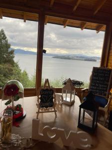 a table with a view of a large window at Glamping Domos del Lago in Aquitania