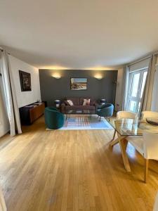 a living room with a couch and a table at Appartement Grand Veneur CityCosy in Paris