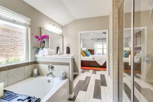 a bathroom with a bath tub and a bedroom at Covered Patio and Yard Spacious Leander Home! in Leander +29 photos