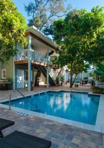 a swimming pool in front of a house at SeaGlass Inn Bed and Breakfast in Melbourne Beach