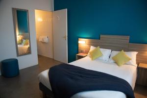 a bedroom with a large bed and a mirror at Clair de Lie in Vallet