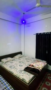 a bedroom with a bed with a purple ceiling at PATEL HOTEL in Shamsgarh