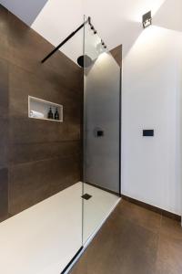 a shower with a glass door in a bathroom at Bohémien Boutique Guesthouse in Cefalù