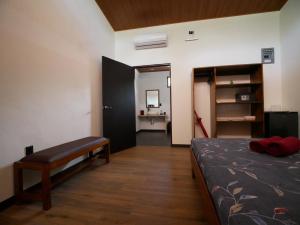 1 dormitorio con 1 cama y 1 habitación con escritorio en Raya, en Matapalo