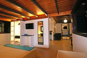 a room with a bed and a living room at Crystalsuite. Beautiful penthouse with sea views in Corralejo