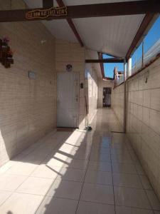 an empty hallway of a building with a door at Balneário Jussara in Mongaguá +1 photo