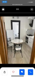 a kitchen with a table and chairs in a room at Appartement a tunis in Tunis