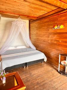 a bedroom with a bed with a mosquito net at el arca in Cartagena de Indias