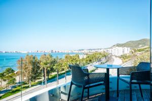 a balcony with chairs and a view of the ocean at Yacht Hotel in Vlorë