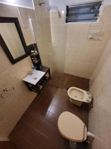 a bathroom with a toilet and a sink at Otto's Haus in Villa General Belgrano