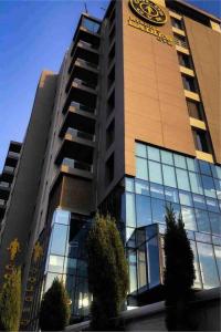 a building with a clock on the side of it at Luxury 2-bedroom Apartment Abdoun tower in Amman