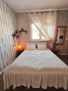 a bedroom with a large white bed with a window at Lawendowy Raj in Pilchowice