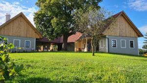 a house with a tree in the yard at WEIN DOMIZIL Zieger in Neuhaus am Klausenbach