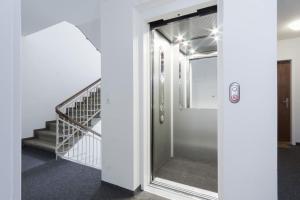 a hallway with a glass door and a staircase at Downtown Deluxe Studio with Queen Bed BE-35 in Zurich