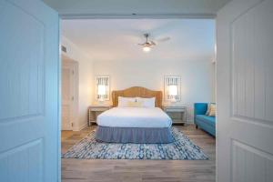a bedroom with a bed and a blue couch at Hawks Cay Resort in Marathon