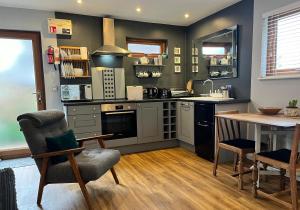 a kitchen with a table and a table and chairs at Wellinghill Lodge in Cheltenham