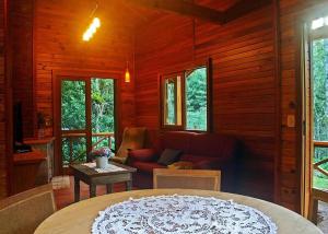 a living room with a couch and a table at Chalets do Vale in Gramado
