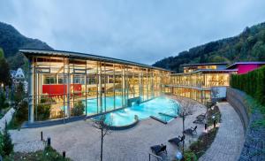 a large building with a pool in front of it at Casa Barzen - Stilvoll Urlauben an der Mosel in Reil