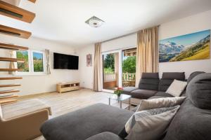 a living room with a couch and a tv at Villa Viktoria with private swimming pool in Donji Muć