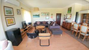 a living room with a couch and a table at Quinta do Sol in Alijó