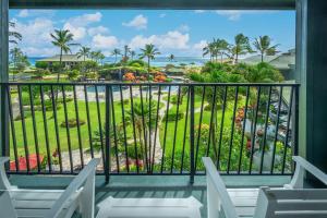 a balcony with chairs and a view of the ocean at OUTRIGGER Kaua'i Beach Resort & Spa in Lihue