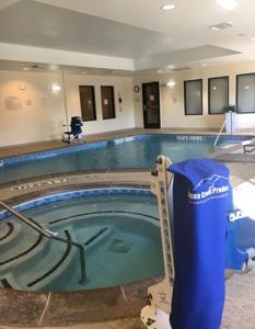 a swimming pool in a hotel with a trash can at Fairfield Inn and Suites by Marriott Dallas Mansfield in Mansfield