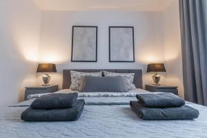 a bedroom with a large bed with pillows on it at Apartment Schwarzwald Panorama in Baden-Baden